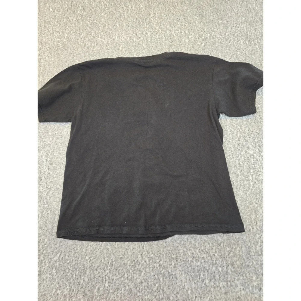 black Looney Tunes t-shirt features a graphic of Bugs Bunny, Wile E. Coyote,...